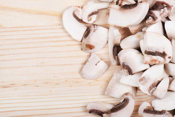 Many mushrooms on wooden table.