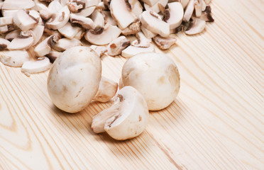 Many mushrooms on wooden table.