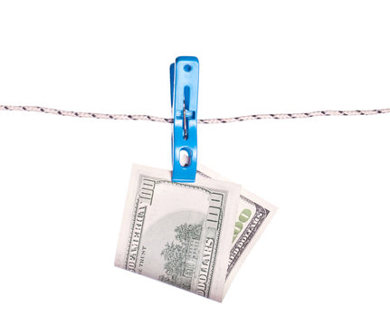Dollar bills hanging on rope attached with clothes pins.