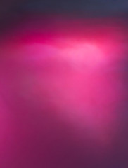 Pink and red colored background on black.