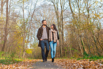 Fototapeta premium Young couple walking through the park