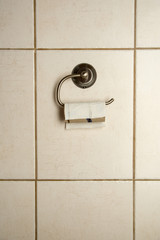 Toilet paper on tiled background. Empty space for text.