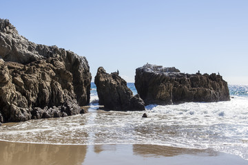 Fototapeta na wymiar Rock formations on a beach in Southern California. 