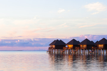 Fototapeta na wymiar Water villas, bungalows on ideal perfect tropical island