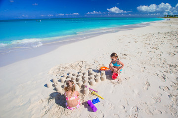 Fototapeta na wymiar Little girls playing with beach toys during tropical vacation
