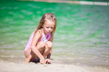 Adorable little girl at beach during summer vacation