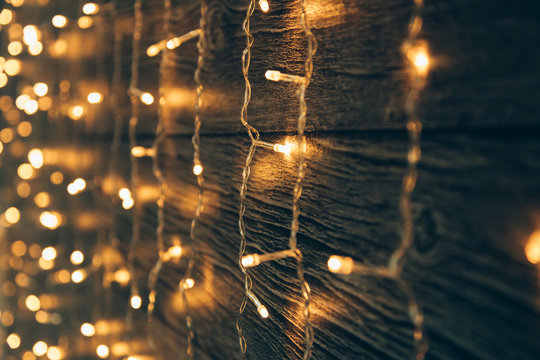 Garland Lights on old grunge wooden board. Christmas and New Year decoration.  Christmas lighting on wooden planks