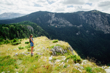 Fototapeta premium woman relax and look at fascinating landscape of mountains