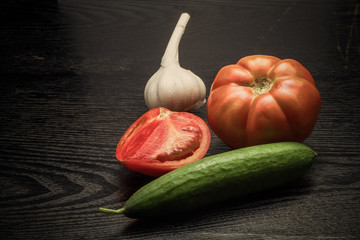 Fresh ripe vegetables on a black table or board like background.