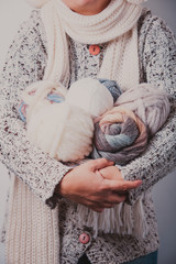 Woman with basket of balls woolen yarn