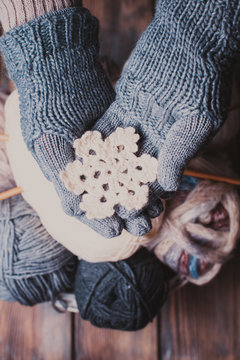 Hands in knitted gloves