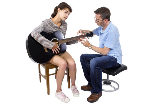 Female looking frustrated with male music instructor teaching how to play guitar
