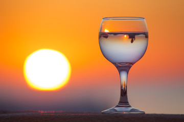 Glass of white vine with reflections of houses and view to beaut
