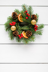 Fototapeta na wymiar Christmas wreath on white wooden table top view