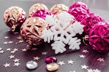 White, magenta and gold christmas ornaments on blurred background. Merry christmas card. Winter holidays. Xmas.