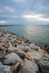 Fototapeta na wymiar Beach with rocks at sunset