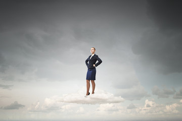 Fototapeta na wymiar Successful businesswoman on cloud