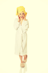 Young smiling woman in bathrobe