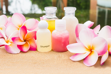 Mini set of bubble bath and shower gel on rock tile floor beside