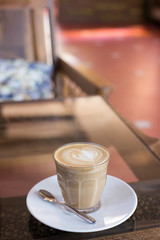 Hot art Latte Coffee in a cup on wooden table