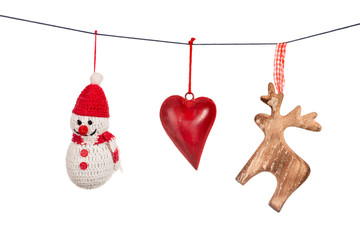 Various Christmas decorations hanging on string isolated