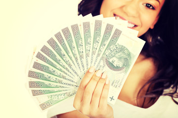 African woman holding polish money.