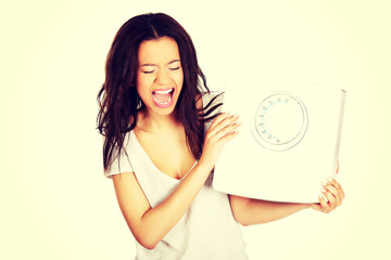 Angry woman holding a scale.