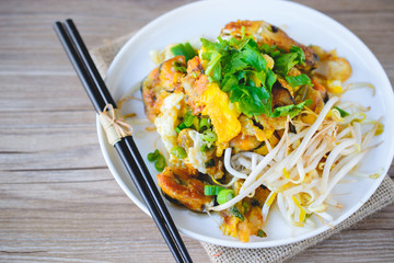 fried mussel pancake with old wooden background