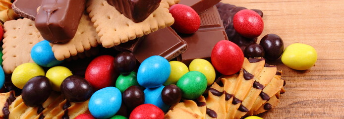 A lot of sweets on wooden surface, unhealthy food