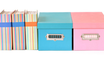 Colorful boxes and binder with blank label on white background