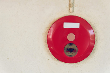 red fire alarm box for warning security system mounted on wall