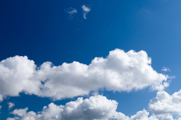 Obraz na płótnie Canvas Blue sky background with fluffy clouds