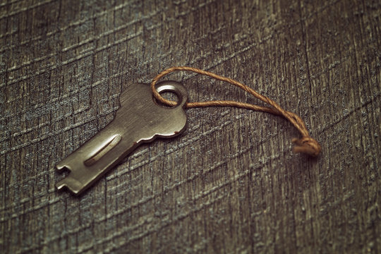 Vintage key on a wooden textured background