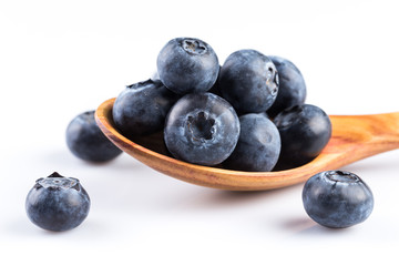 Fresh blueberries in wooden spoon