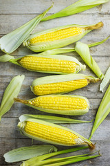 fresh corn on wooden table