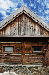 Fototapeta na wymiar wooden barn with cloudy blue sky