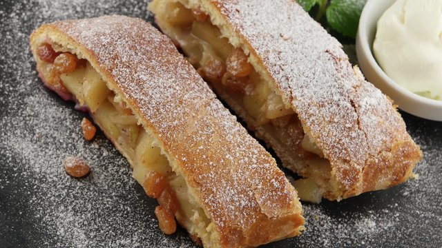 Apple pie (vienna strudel) with ice cream on black slate tray