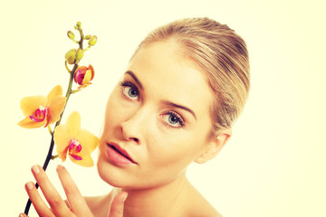Fototapeta premium Beautiful spa woman with orange orchid