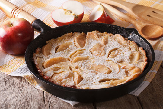 Dutch baby pancake with apples in a pan closeup. Horizontal
