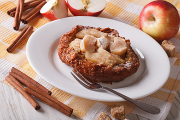 Delicious Dutch baby pancakes with apples on a plate. horizontal

