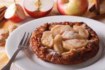 Dutch baby pancake with apples on a plate close-up horizontal

