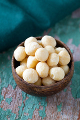 salted macadamia nuts on wooden surface