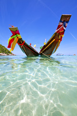    bay isle white  beach    rocks pirogue  in thailand