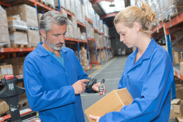 Man scanning box with computerized scanner