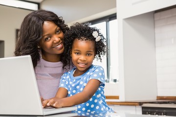 Daughter using laptop with mother 