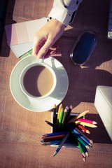 Cropped image of woman holding coffee cup