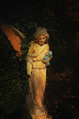 sculpture of an angel with dark background