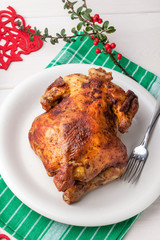 Baked chicken on white plate.