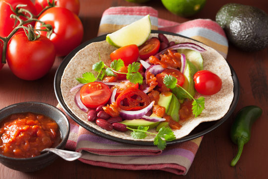 vegan taco with avocado tomato kidney beans and salsa
