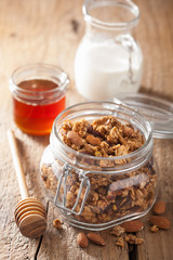 homemade healthy granola in glass jar and honey